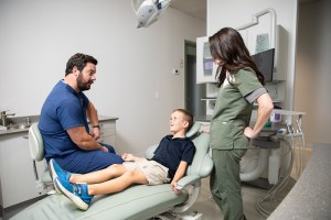 Dentist discussing plan with child patient